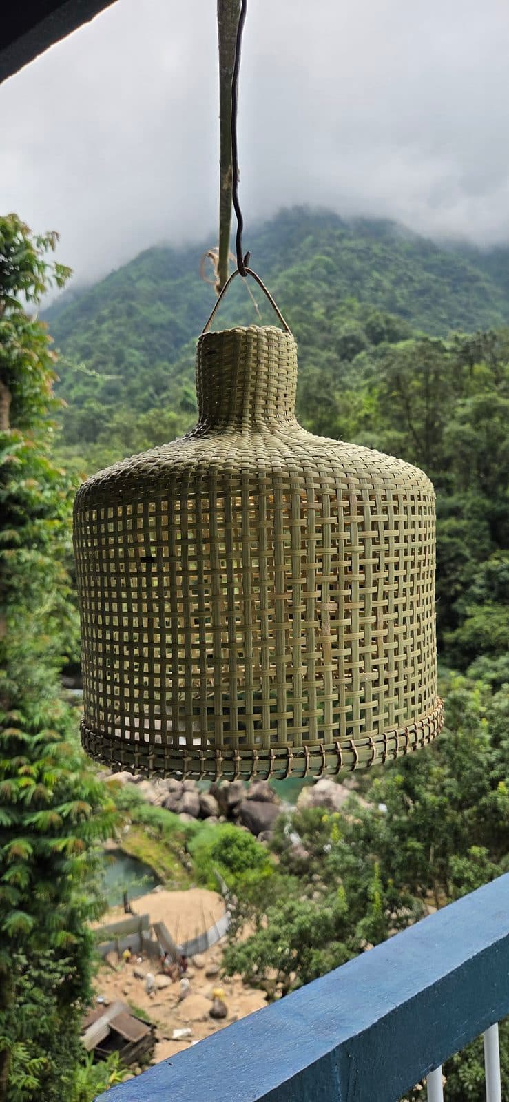 Handwoven bamboo bell shade seen from the side