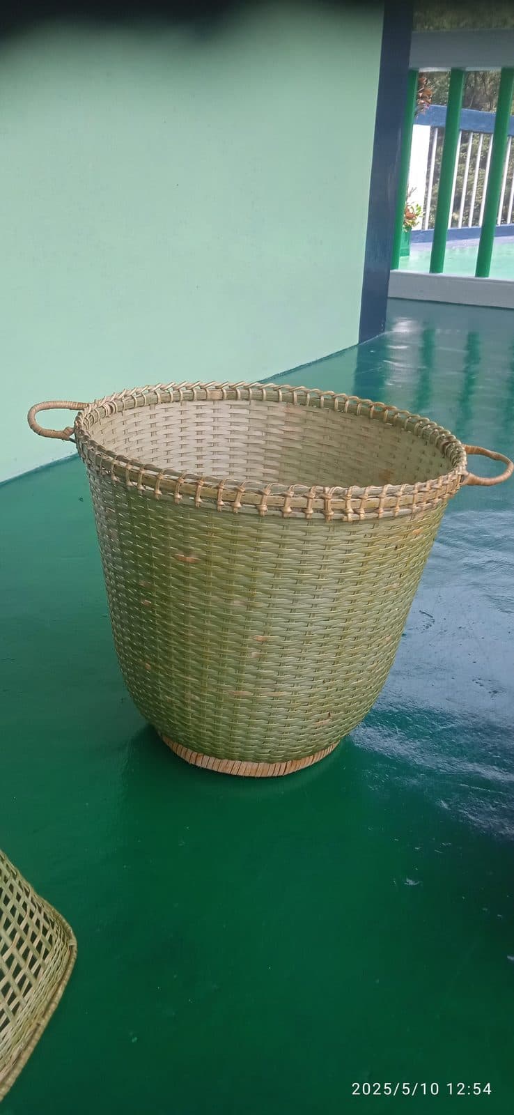 Tall round cane laundry basket with side loop handles