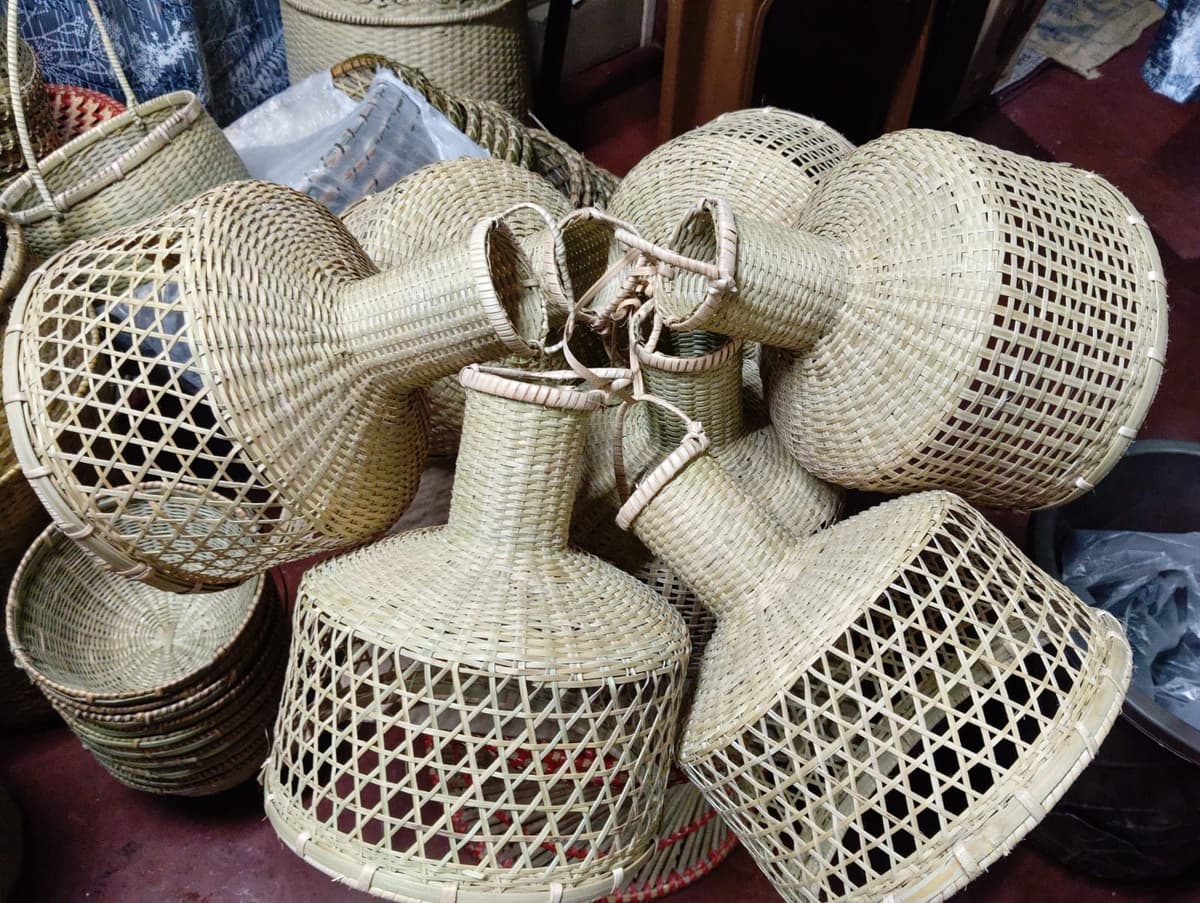 Finished bamboo pendant shades gathered together in a workshop